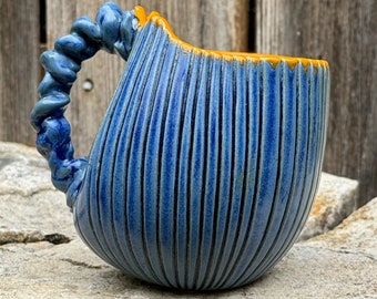 handmade whimsical porcelain mug in blue and orange
