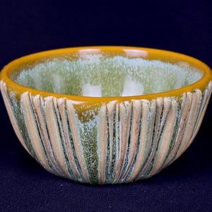small handmade porcelain bowl in green and orange