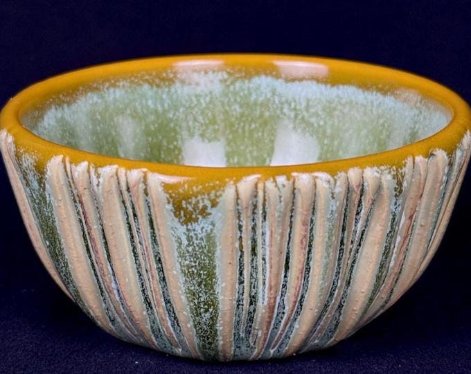 small handmade porcelain bowl in green and orange
