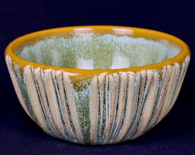 small handmade porcelain bowl in green and orange