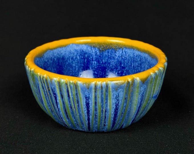 small handmade porcelain bowl in blue and orange