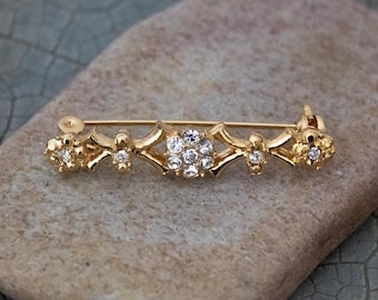 Vintage Gold Tone Metal Elongated Brooch with Rhinestones in Floral Design: DX Brand Jewelry