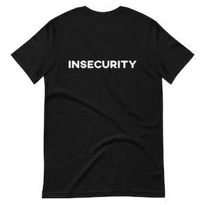May include: Black t-shirt with the word "INSECURITY" printed in white on the back.
