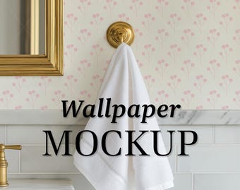 May include: A white towel hangs from a brass hook against a floral wallpaper backdrop. The wallpaper features a repeating pattern of pink flowers on a cream background. The text "Wallpaper MOCKUP" is displayed in black.