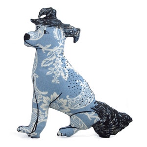 May include: A blue and white patterned dog plush toy with black ears and a black tail. The dog is sitting on its hind legs with its front paws extended.