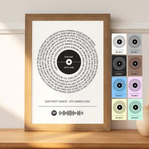 May include: A wooden framed print with a circular design featuring song lyrics and a record graphic. The text "OUR FIRST DANCE - 5TH MARCH 2012" is below the design, along with a Spotify code. The frame is made of wood.