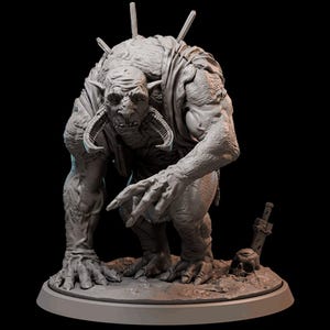 May include: A grey monster figurine with horns and spikes, pointing with one hand. A sword and skull lie at its feet. The figure has a menacing expression, suggesting a fantasy or horror theme.