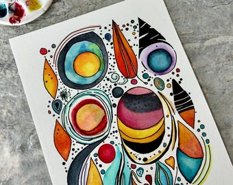 May include: Abstract watercolor painting with a variety of shapes and colors. The artwork features circles, teardrops, and other organic forms in shades of blue, orange, yellow, and purple. Black outlines define the shapes, and small dots add detail.