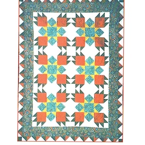 May include: A quilt with a white background and a repeating pattern of red, blue, yellow, and green squares and triangles. The quilt has a dark green, blue, and red border.