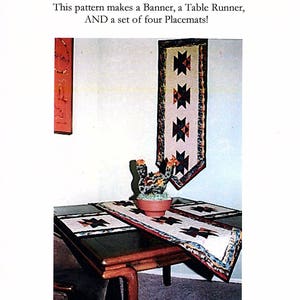 May include: A quilting pattern called "Phoenix" #EA103. This pattern makes a banner, a table runner, and a set of four placemats. The pattern features a geometric design with red, blue, and white fabric.