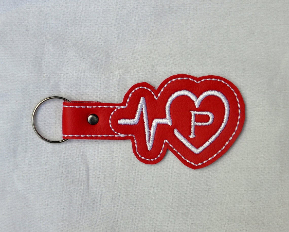 embroidered red vinyl with a heart and a heartbeat with an initial