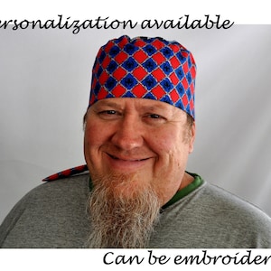 May include: A man wearing a red and blue patterned surgical cap with a diamond pattern. The cap has the text "Personalization available" and "Can be embroidered" on the image.
