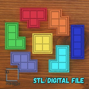 Puede incluir: Una colección de coloridas piezas geométricas del juego Tetris en rojo, naranja, amarillo, verde, azul y cian. Cada pieza tiene un contorno negro y un patrón de cuadrícula en el interior. El texto "STL/DIGITAL FILE" está en la parte inferior.