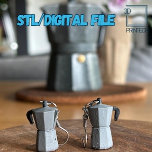 May include: A pair of silver earrings shaped like miniature gray coffee pots. The earrings are hanging from a wooden surface. The text "STL/DIGITAL FILE" and "3D PRINTEC" are visible in the background.
