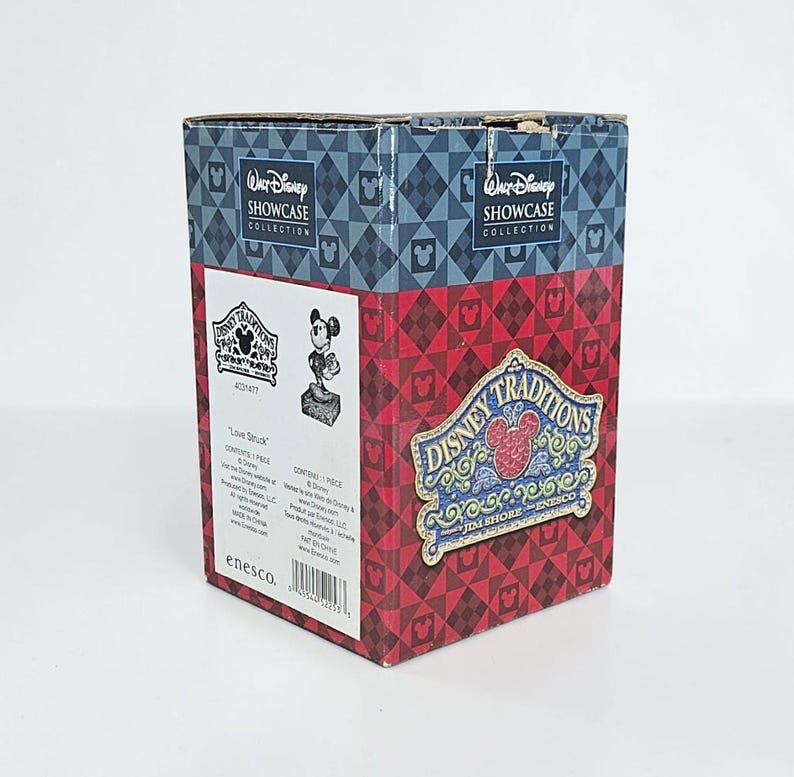 May include: A Disney Traditions box with a red and blue diamond pattern. The box features the Walt Disney Showcase Collection logo and a Mickey Mouse figurine. The box also has the text "Love Struck" and the Disney Traditions logo.