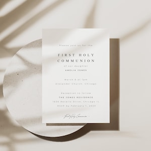 May include: A First Holy Communion invitation with a minimalist design. The card features the text "FIRST HOLY COMMUNION" and event details for Amelia Jones. The design uses a neutral colour palette and elegant typography. The invitation is on a white card.