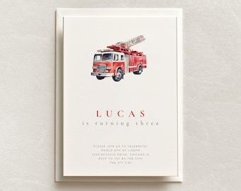 May include: A red fire truck with a white ladder is featured on a white invitation card. The text "LUCAS is turning three" is printed in red. The invitation includes details for a birthday party, including the date, time, address, and RSVP information.