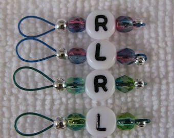 May include: Four stitch markers with white beads and black letters, 'R' and 'L', alternating. Each marker has a silver bead and a blue or green bead.