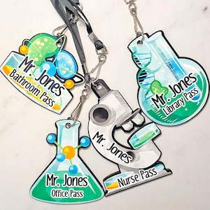 May include: Four colorful lanyards with different science-themed designs. Each lanyard has a different pass type: Bathroom, Office, Library, and Nurse. Each lanyard features the text "Mr. Jones" and the corresponding pass type.