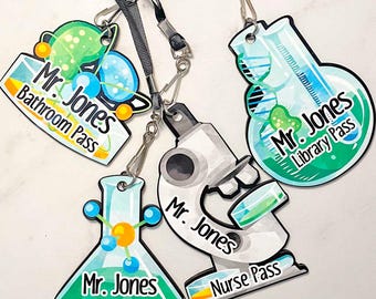 May include: Four colorful lanyards with different science-themed designs. Each lanyard has a different pass type: Bathroom, Office, Library, and Nurse. Each lanyard features the text "Mr. Jones" and the corresponding pass type.