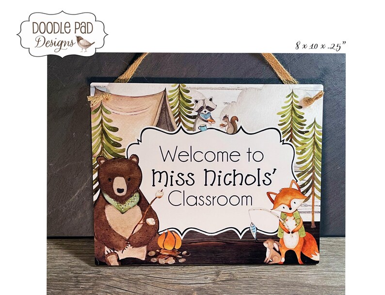 May include: Wooden sign with the text "Welcome to Miss Nichols' Classroom." The sign features illustrations of a bear, fox, raccoon, and squirrel in a forest setting. The sign measures 8 x 10.25 inches.