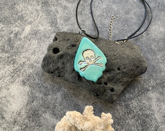Skull and crossbones turquoise ceramic pendant, porcelain pendant necklace, stamped, mother of pearl, waxed black cord