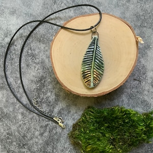 Green leaf ceramic pendant, porcelain pendant necklace, gold luster, waxed black cord, ceramic jewelry, stamped texture
