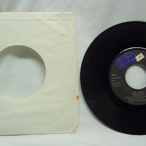 May include: A black 45 RPM vinyl record with a white label. The label has the text "Real Folk Speciality" and "My Love" by Bill McMurray & Rene. The record is in a white paper sleeve.