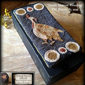 May include: A black wooden box with a needlepoint design of a brown and white bird with red accents on a dark blue background. The box has a label that reads "Vermont Harvest Folk Art Original Needlework Creations by Doreen Frost" and "Goode Mistress Woodson PN Pattern #5 2016".
