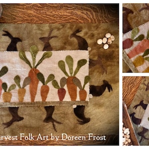 May include: A rectangular textile with a carrot design and the text "Vermont Harvest Folk Art by Doreen Frost." The carrots are in shades of orange, pink, and yellow with green tops. Brown rabbit silhouettes are in the background.