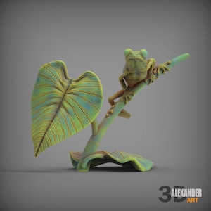 May include: A green frog figurine perched on a branch with a large green leaf. The frog has a textured surface and realistic details. The branch is made of a brown material and has a textured surface. The leaf is made of a green material and has a textured surface.