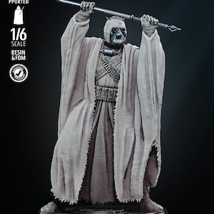 May include: A 1/6 scale resin and FDM printed figure of a Star Wars character wearing a hooded robe and holding a staff. The figure is posed in a dynamic action pose. The figure is painted in a realistic style with a weathered and worn look. The figure is standing on a base with the text "SW3D PATREON" printed on it.