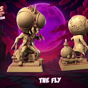 May include: Two beige statues of "The Fly" from the "Classic Monsters" series. One is seated, the other standing, both on a base with laboratory equipment. The background shows a graveyard with a purple moon and red sky.