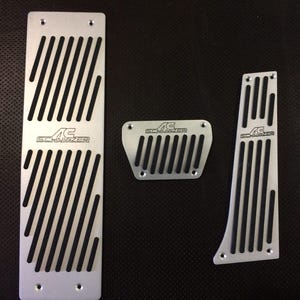 May include: A handmade wooden sign with the text "Welcome" in a playful font. The sign is painted white with a distressed finish, and features a small, decorative heart. It's designed for indoor or outdoor use.