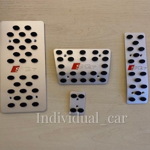 May include: Set of five silver-colored car pedal covers with black rubber inserts. Each cover has the red letters "SQ7" printed on it. The text "Individual_car" is printed at the bottom of the image.