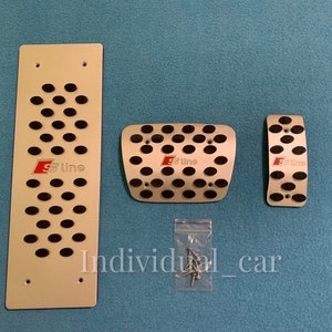 May include: Set of three silver-colored car pedal covers with black rubber inserts. The covers have the text "S Line" in red. Includes a long rectangular plate, a square plate, and a smaller rectangular plate. The text "Individual_car" is visible.
