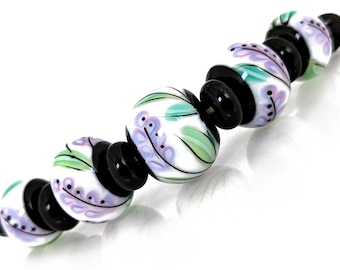 Purple floral illustration on white bead set, Contemporary Illustration in Glass, handmade lampwork beads by JC Herrell