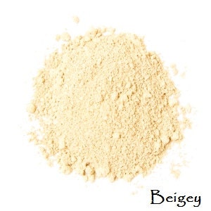 May include: A close-up of a pile of beige powder. The word "Beigey" is written in cursive below the powder.