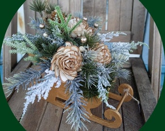 Holiday Golden Sleigh Arrangement with Sola Wood Flowers and Frosted Greenery