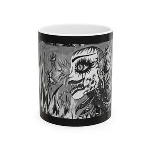 May include: A black and white ceramic mug with a surreal illustration. The design shows a profile of a face with dramatic makeup, set against stylized plants and butterflies. The mug has a black rim and base.
