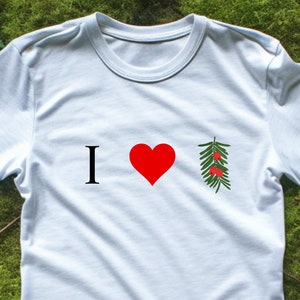 May include: White t-shirt with the text "I love" and a red heart, followed by a green sprig with red berries.