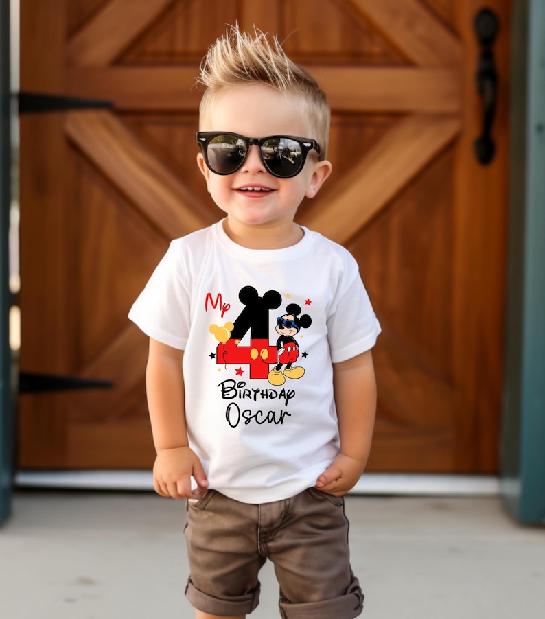 May include: White t-shirt with a red number four and Mickey Mouse wearing sunglasses. The text on the shirt reads "My 4th Birthday Oscar".