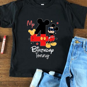 May include: Black t-shirt with a red number four and Mickey Mouse wearing sunglasses. The text "My 4th Birthday Tony" is printed on the shirt.