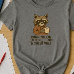 Raccoon Coffee Lover Tee, Caffeine Chaos Teacher Shirt, Unisex T-shirt Gift, Funny Animal Graphic Top, Cute Critter School Tee, Novelty