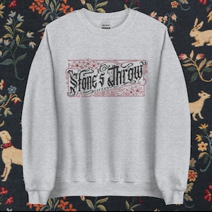 May include: Gray sweatshirt with a red and black graphic design that says "Stone's Throw Tavern".