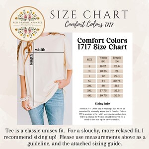 May include: A cream-colored t-shirt with a size chart for Comfort Colors 1717. The chart lists sizes S to 4XL with width and length measurements in inches. The shirt is a unisex style, and the model is wearing an XL for an oversized fit.