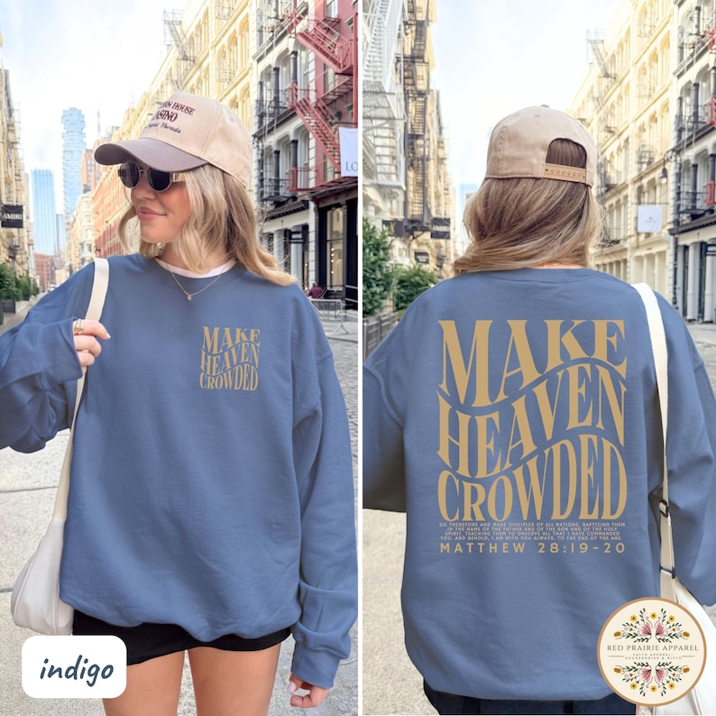May include: A blue crewneck sweatshirt featuring the text "MAKE HEAVEN CROWDED" in gold lettering on the front left chest and a larger version of the same text on the back, accompanied by the Bible verse Matthew 28:19-20 in smaller gold print.