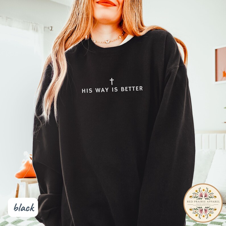 May include: Black sweatshirt with the text "HIS WAY IS BETTER" and a cross graphic. The sweatshirt is a crew neck style. The words and cross are in white. The sweatshirt is a solid black color.
