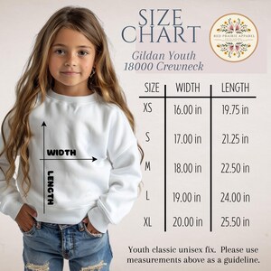 May include: A white Gildan Youth 18000 crewneck sweatshirt size chart. The chart lists sizes XS through XL with corresponding width and length measurements in inches. A diagram on the sweatshirt illustrates how to measure width and length.