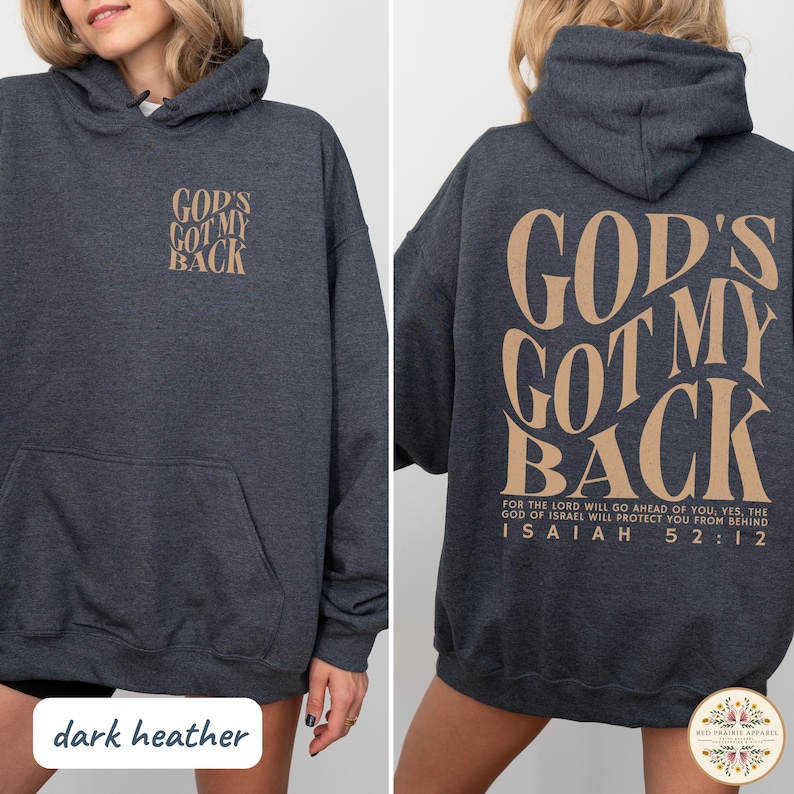 May include: Dark heather gray hoodie with the text "GOD'S GOT MY BACK" in a tan color on the front and back. The back also features a Bible verse. The hoodie has a front pocket and a hood.